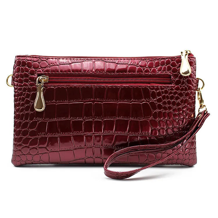 Women's black PU messenger bag showing horizontal square shape and shoulder strap