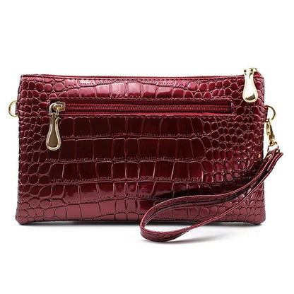 Women's black PU messenger bag showing horizontal square shape and shoulder strap