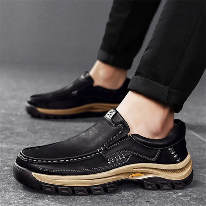 Men's black leather mountaineering shoes with thick rubber sole and round toe.