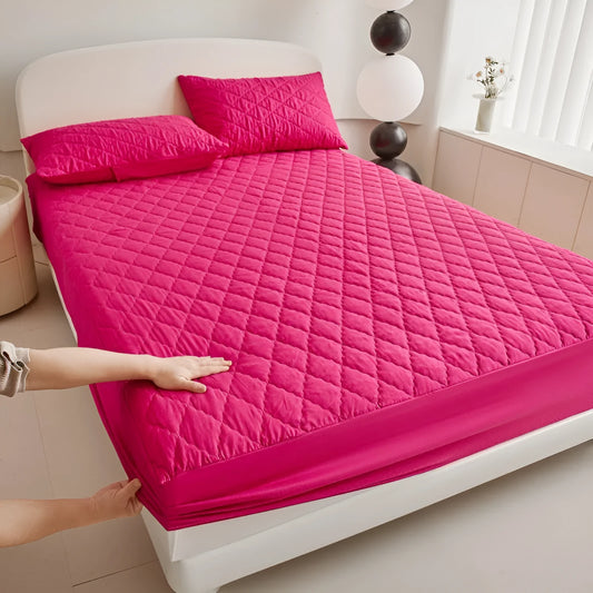 Diamond lattice quilted bamboo fibre mattress protector set in solid colour on a bed.