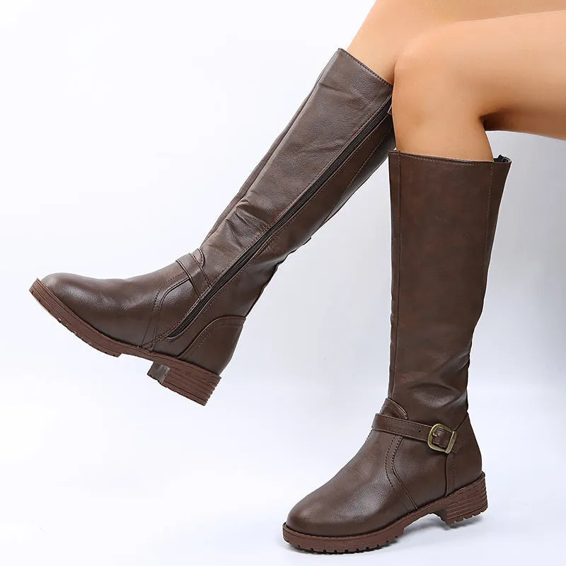 Women's black high knight boots with a square heel, round toe, and ankle buckle detail.