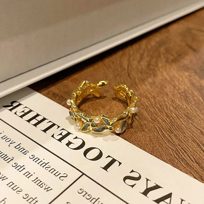 Copper women's ring with Chinese butterfly design and adjustable open loop.