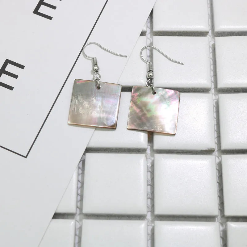 Natural shell earrings in geometric square and rectangular shapes with panther pattern detailing