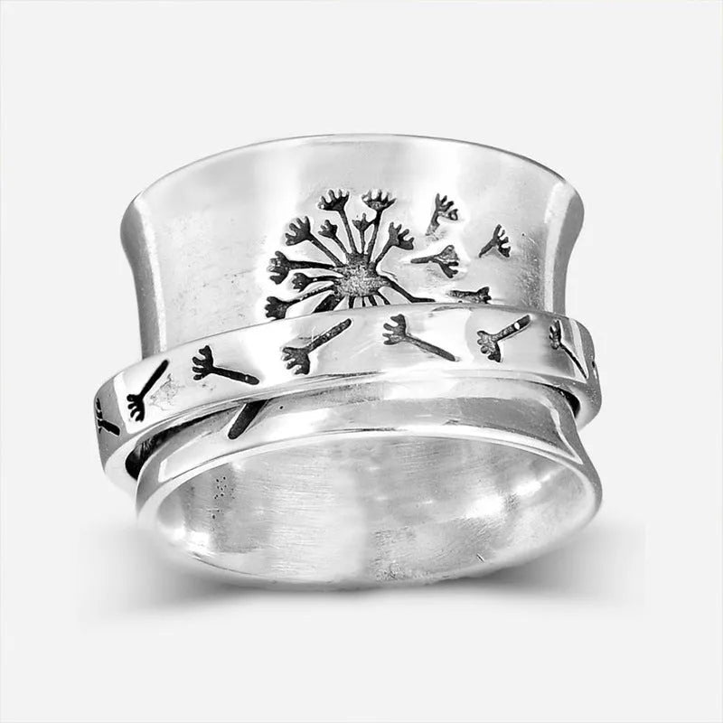 Silver-coloured rotating flower ring on finger showing adjustable floral element