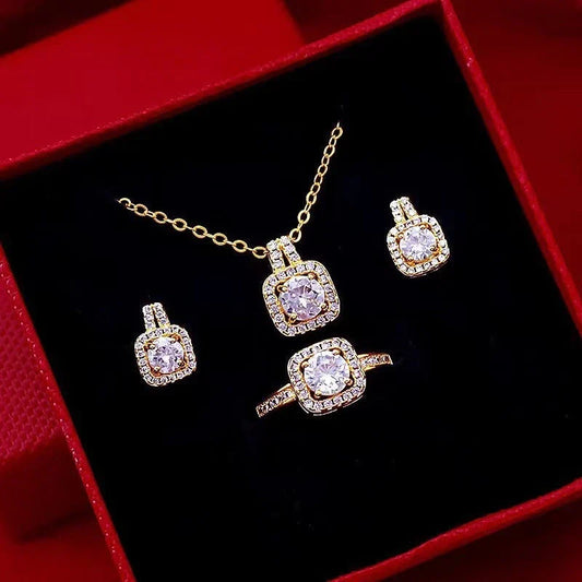 Elegant gold-toned jewelry set including necklace, earrings, and ring with zircon gemstone pendant