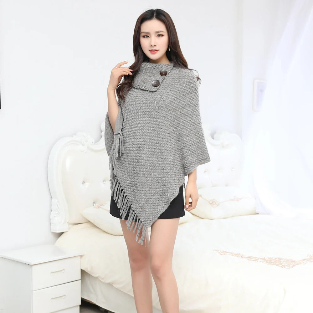 Sleeveless polka dot shawl in apricot colour draped over chair, showing 150cm length and acrylic fibre texture