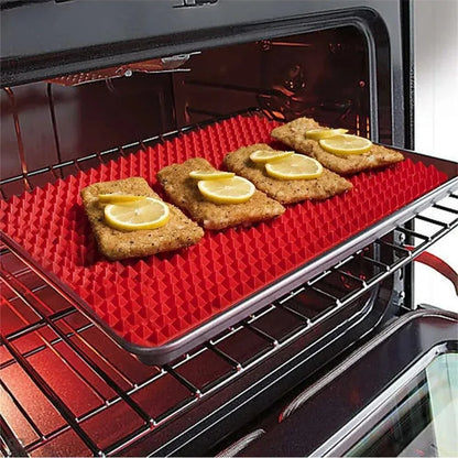 Red silicone pyramid grid cooking mat on a kitchen counter