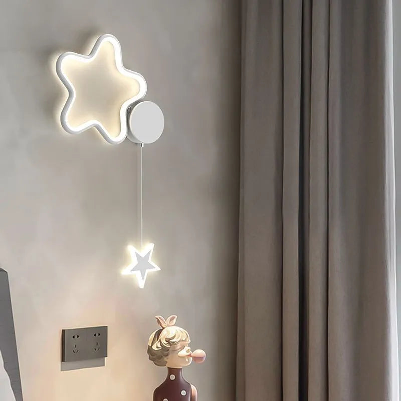 Black five-pointed star shaped children's wall lamp with a left-facing cloud design and touch control for three colour LED light.
