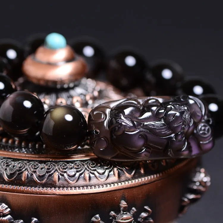 Natural Icy Obsidian crystal Pi Xiu bracelet with polished beads in ethnic geometric style.