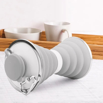 Collapsed and expanded states of a 500ml silicone water bottle with hook and hand rope.