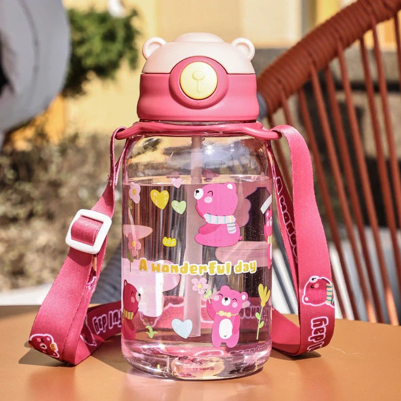 Red children's water cup with shoulder strap showing cartoon pattern and suction nozzle