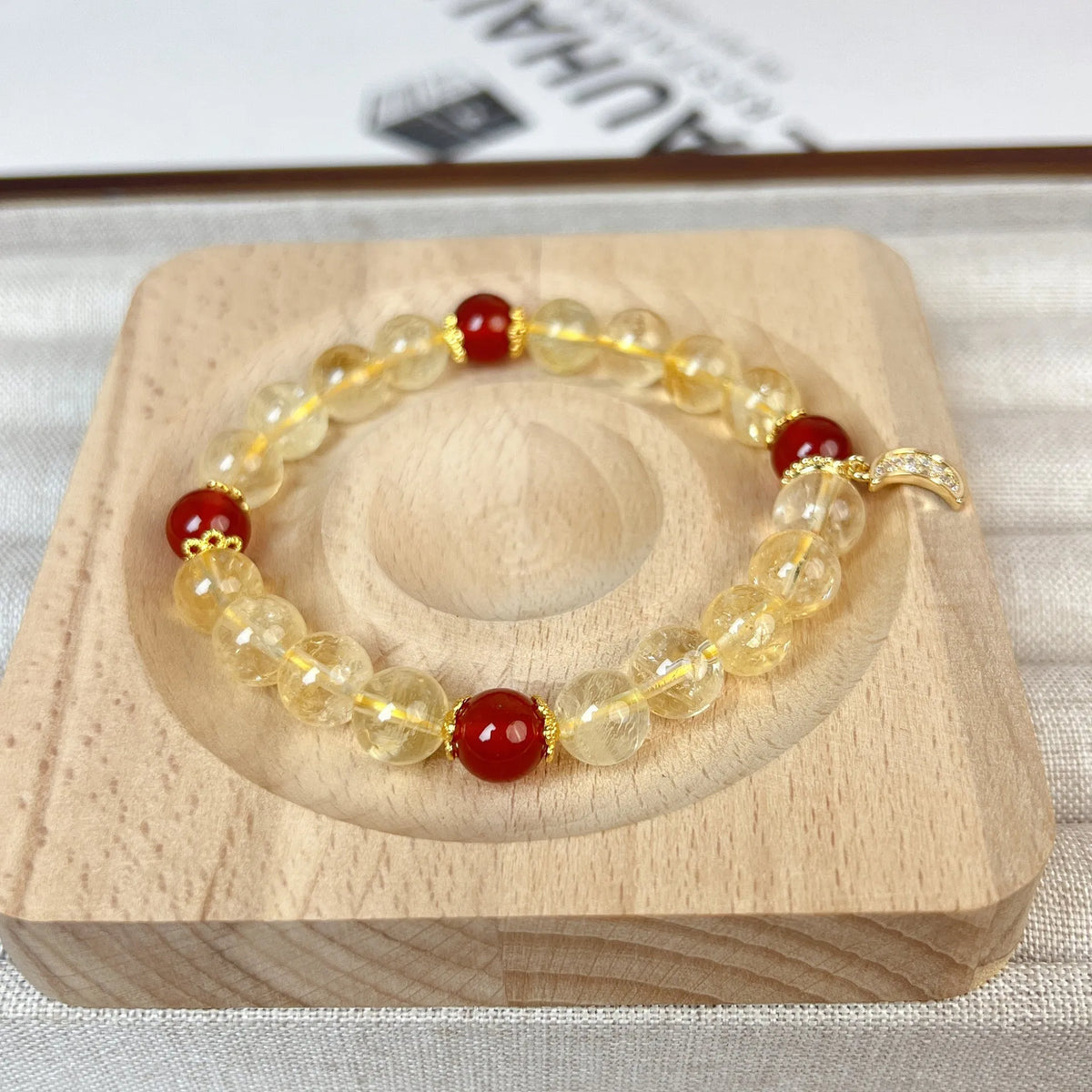 Citrine red agate moon boom crystal bracelet for women on a white background.