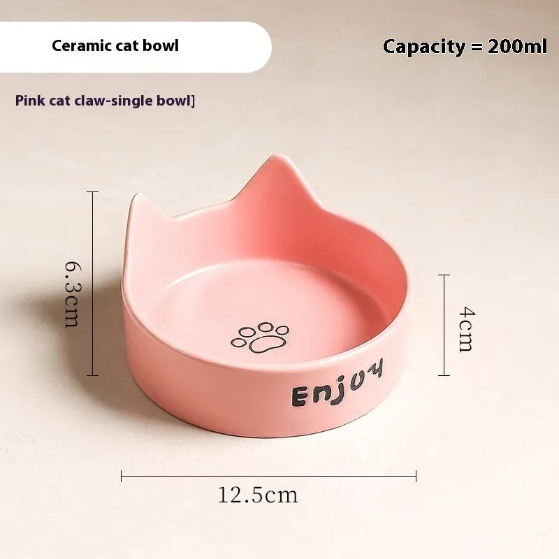 Porcelain cat bowl with anti-tumble wooden frame in pink with a cat paw design
