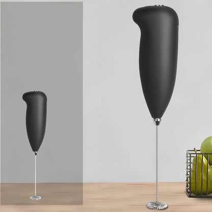Green electric milk frother measuring 21cm tall with 5cm base creating milk foam