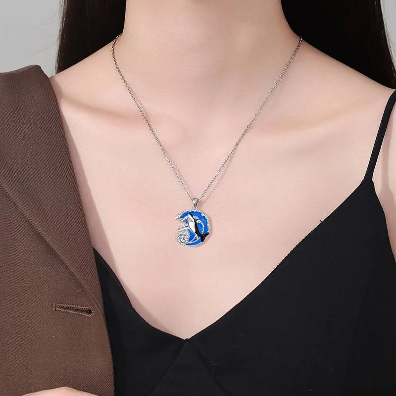 Close-up of a women's shark pendant necklace on a cross chain, showing detailed copper animal modelling.