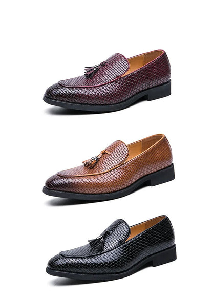 Men's black pointed toe slip on shoe with a decorative tassel on the artificial PU upper.