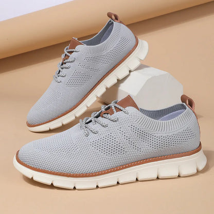 Men's grey and black low-top casual sneakers with a breathable mesh fabric upper.