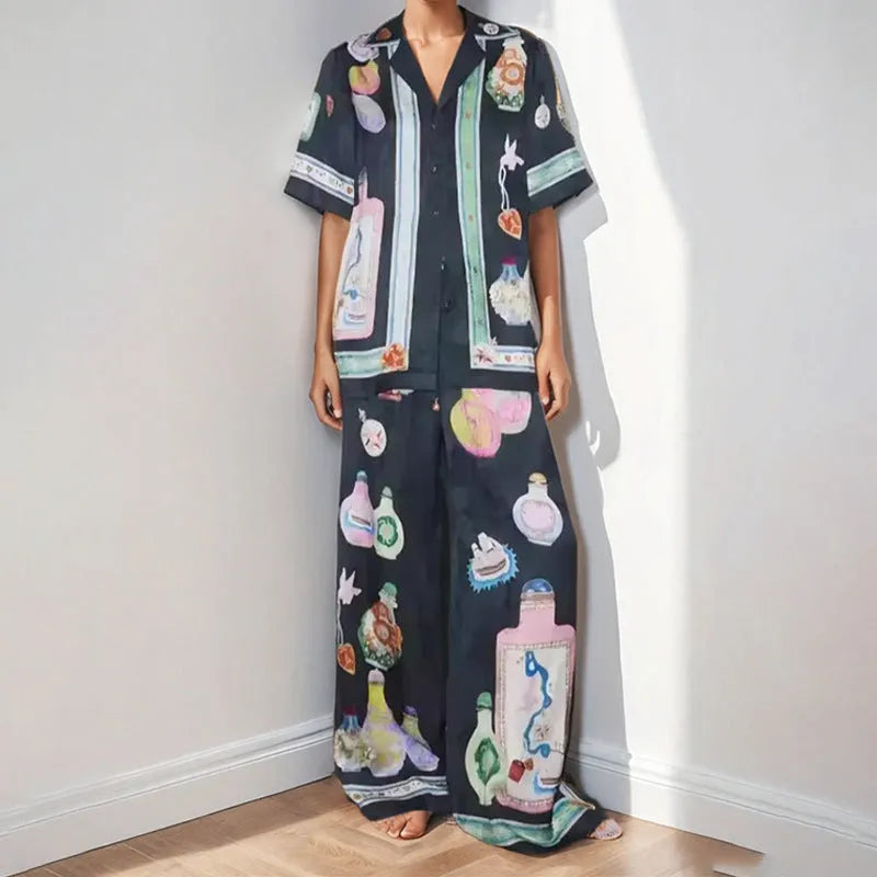 Black women's cardigan set with cartoon animation print, showing top with regular sleeves and matching trousers