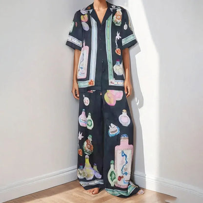Black women's cardigan set with cartoon animation print, showing top with regular sleeves and matching trousers