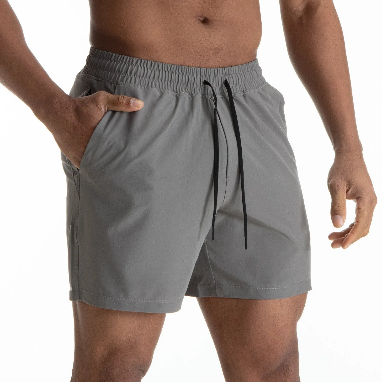 Man wearing black quick-dry polyester sports shorts suitable for running or gym workouts.