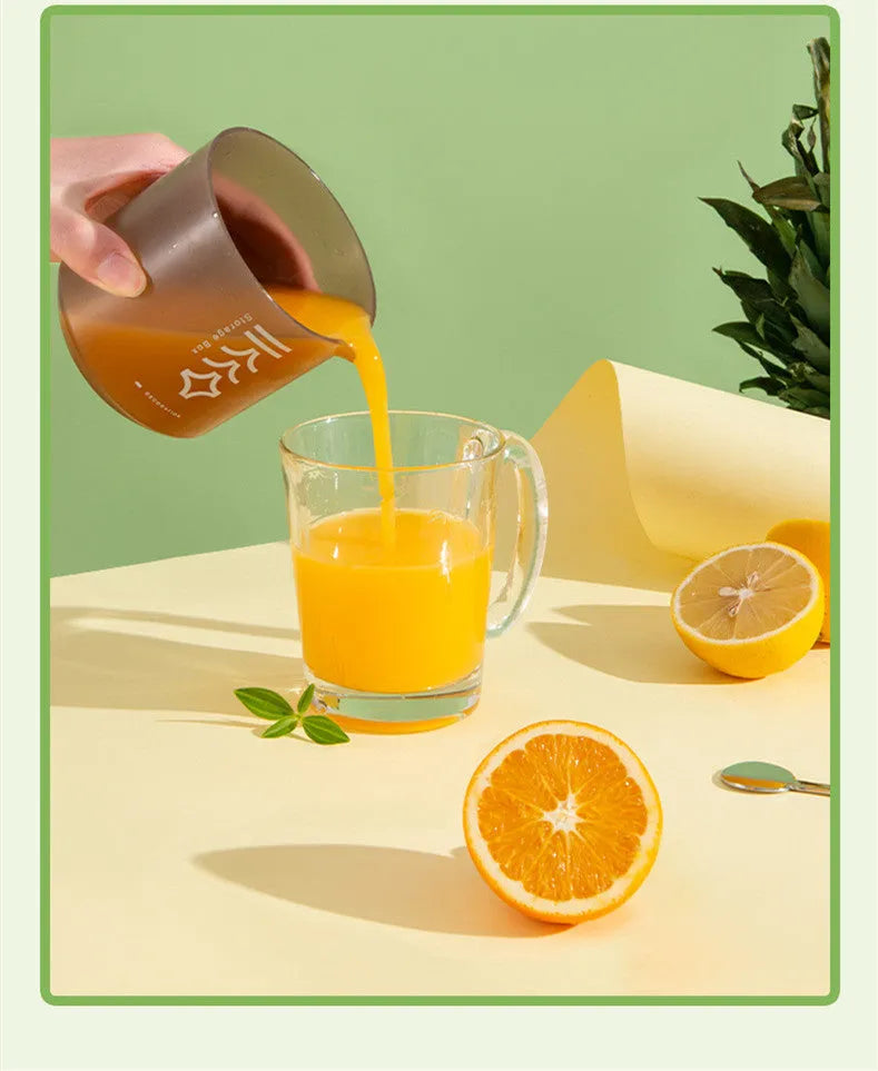 Green manual citrus juicer with lemon on counter, showing compact 180mm size.