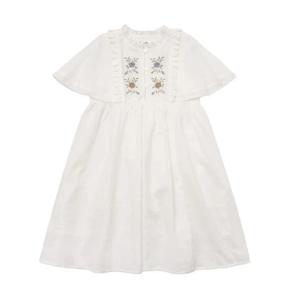 White cotton girls dress with embroidered skirt detail, short sleeves, and Western style silhouette