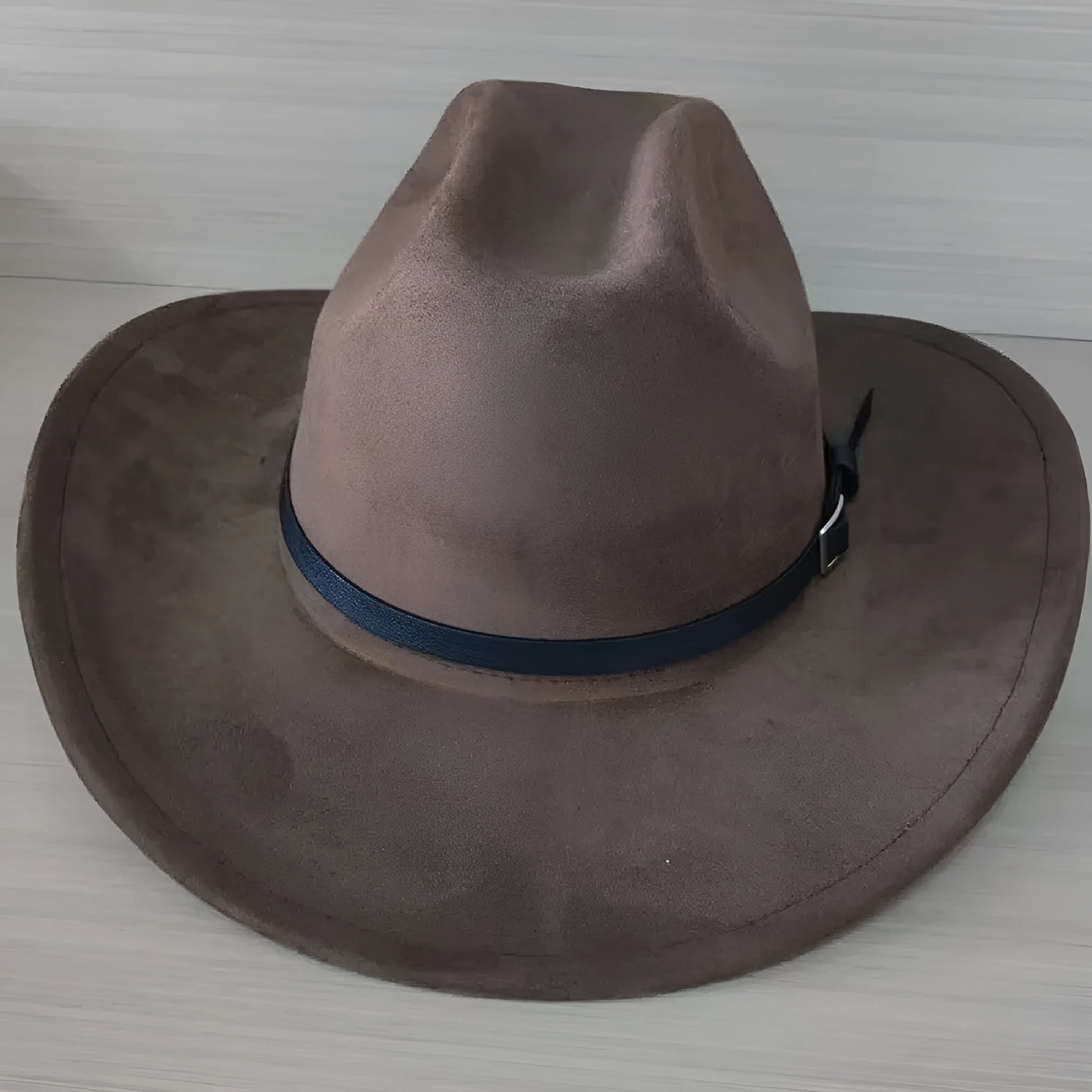 Brown leather velvet cowboy hat with curved brim and conical crown.