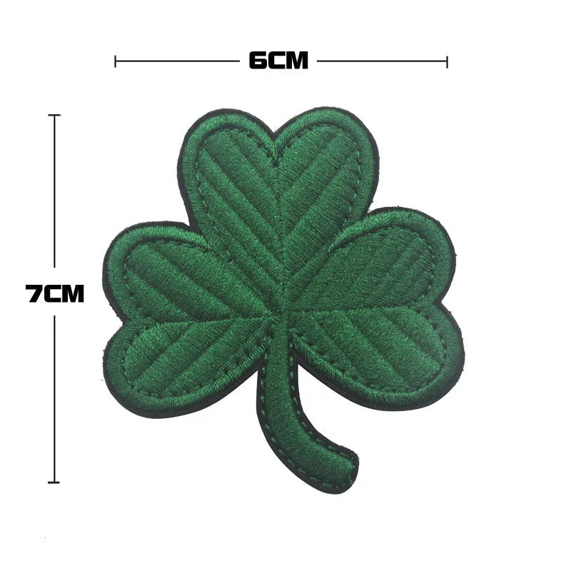 Outdoor embroidered fabric badge with Velcro strip backing, available in 12 distinct designs including Cross Green and Skull Flower variants, suitable for industrial use, clothing, and home textile applications.