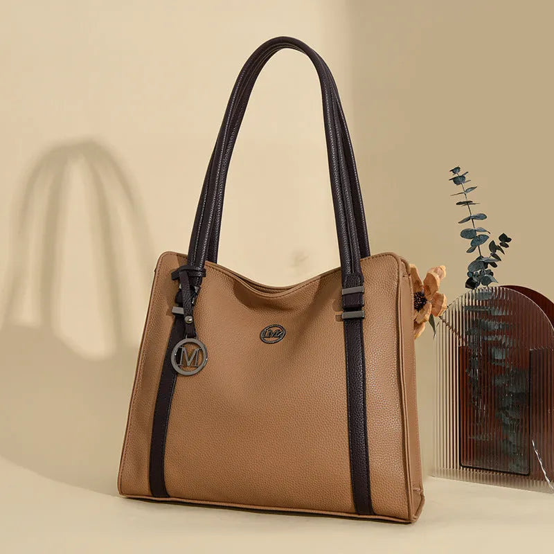 A soft PU leather women's crossbody bag in a retro style with double shoulder straps, shown in a choice of colours.