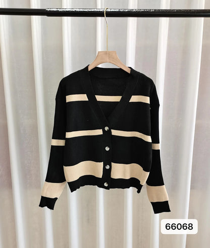 Women's black and white striped V-neck cardigan with buttons, showing a textured 3D knit pattern.