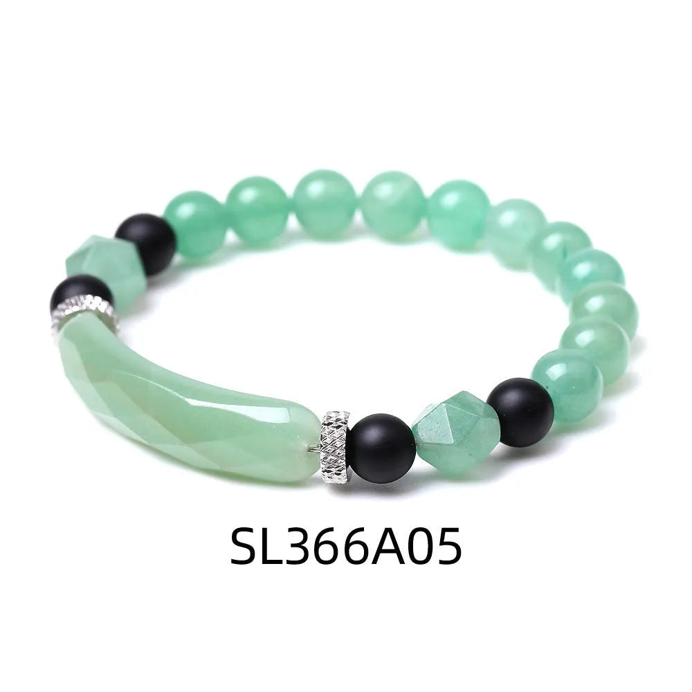 Handmade diamond-shaped cut black agate bracelet with fan-shaped details on a wrist.