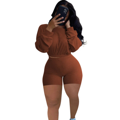 Women's long sleeve off-the-shoulder top and shorts two-piece set in a solid colour.