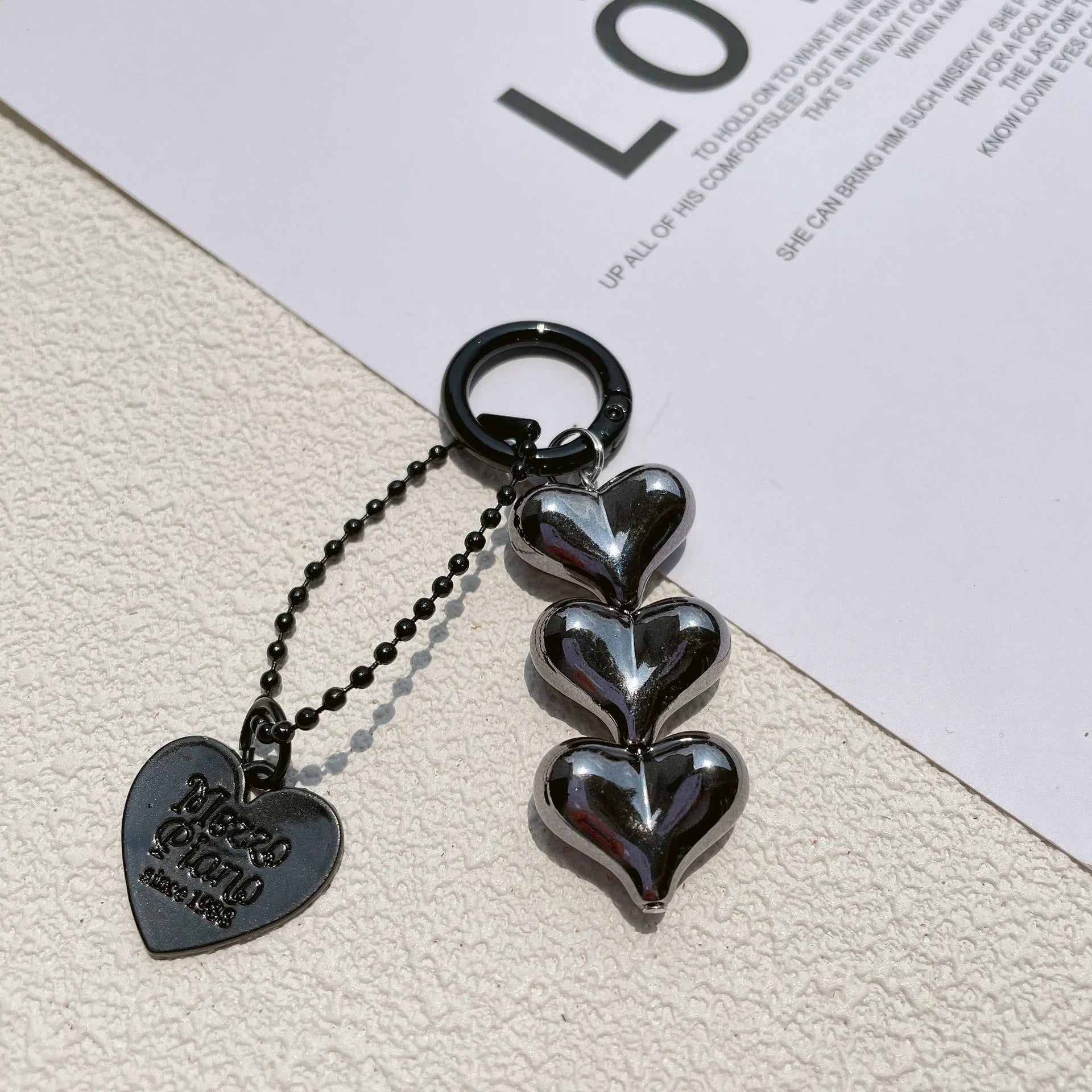 Acrylic key ring with an electroplated decorative charm in a choice of heart, bell, or water drop shapes.
