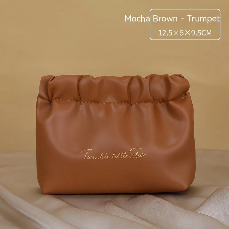 Leather travel toiletry bag with dry-wet separation compartments in caramel mocha colour with letter detailing