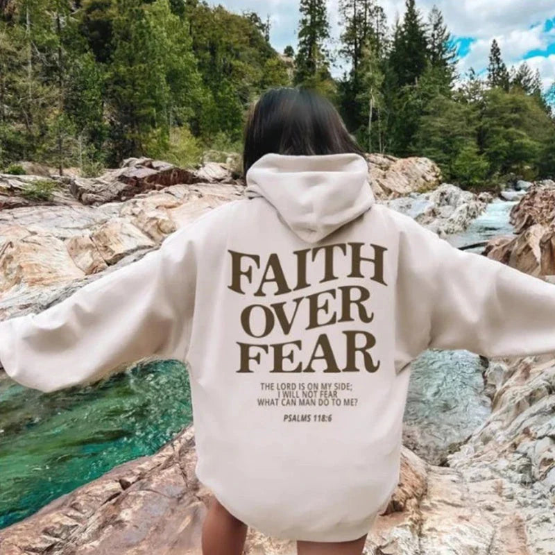 A stylish Christian hoodie with inspirational graphics and a message of faith over fear