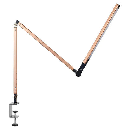 Clip-on adjustable arm LED desk lamp in black mounted on a desk edge with remote control.