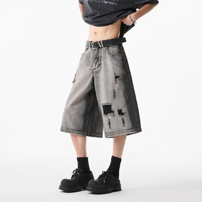 Grey women's denim shorts with distressed holes and water washed finish, loose cropped fit