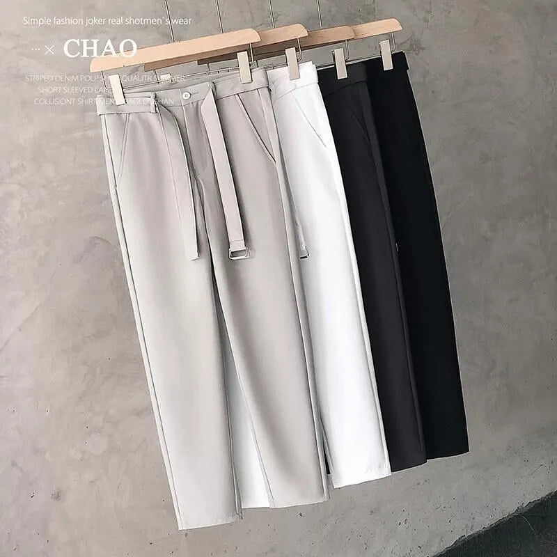 Boys slim straight wool trousers in a tapered fit, shown in a light grey colour.