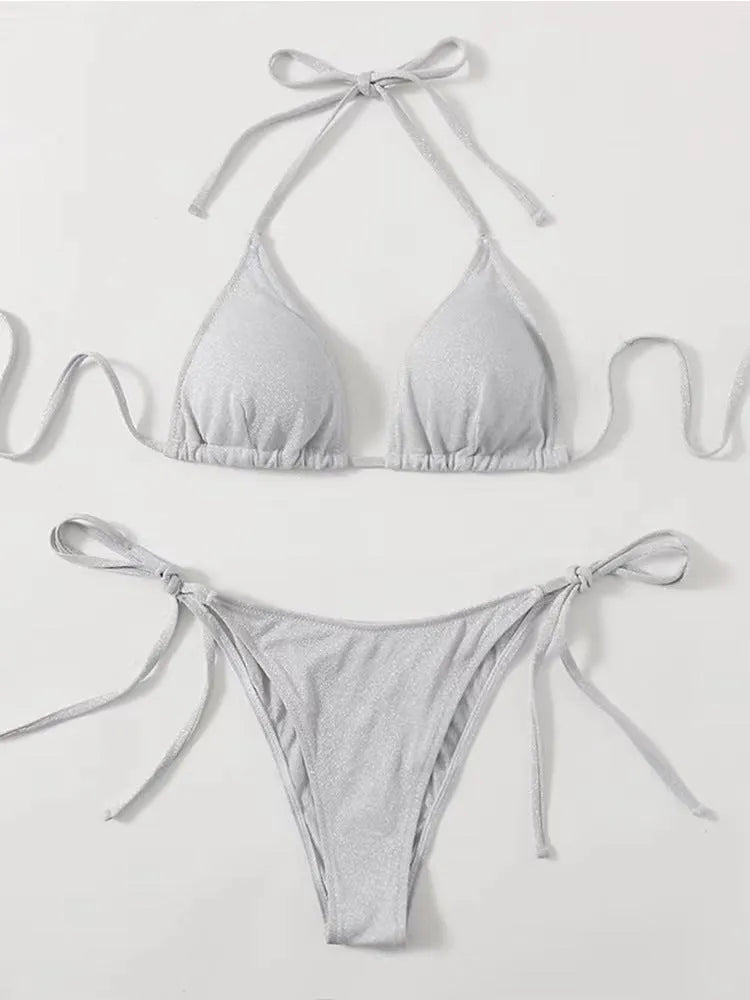 Women's khaki gold bandage style bikini with structured panels on a neutral background
