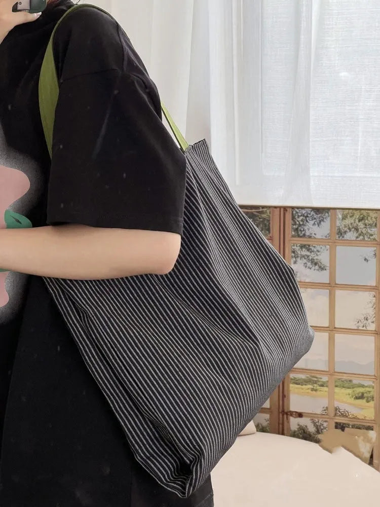 Light pink striped cotton canvas multi-layer tote bag with a wide shoulder strap.