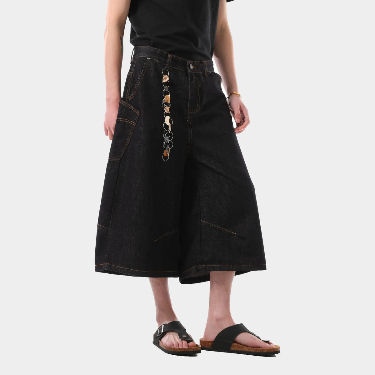 Men's black retro washed denim cropped pants with straight legs and side pockets laid flat