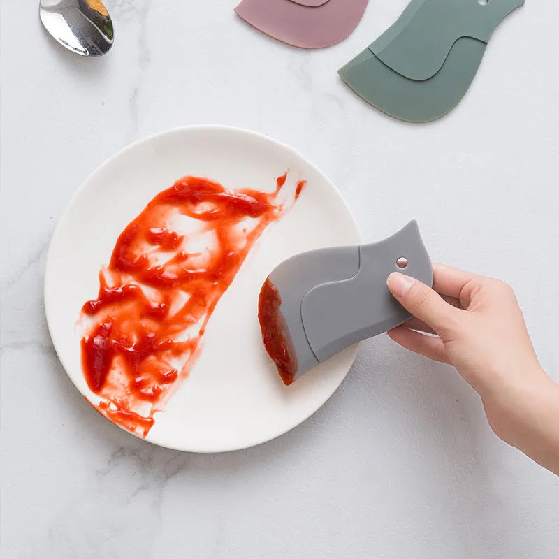 Penguin-shaped silicone kitchen scraper with soft blade for cleaning plates and pots