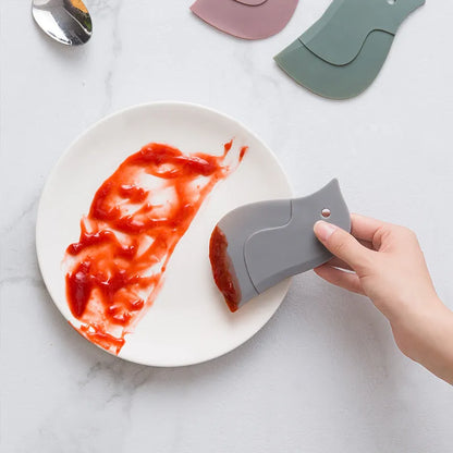 Penguin-shaped silicone kitchen scraper with soft blade for cleaning plates and pots