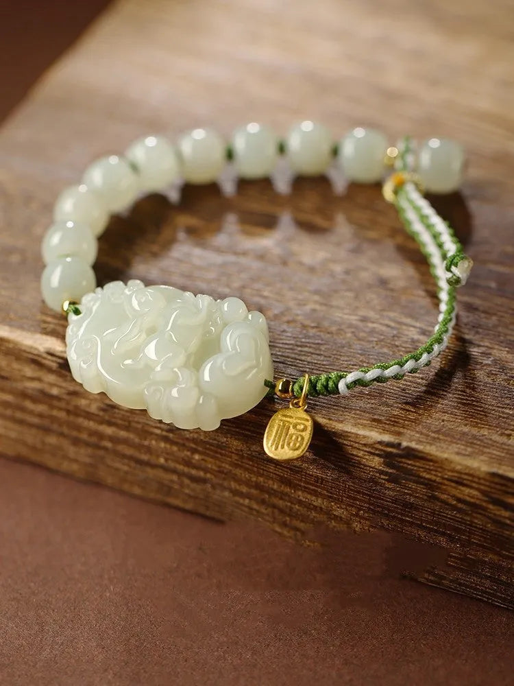 Hetian jade bracelet with a rabbit zodiac charm and S925 silver card on a red ice cotton rope.