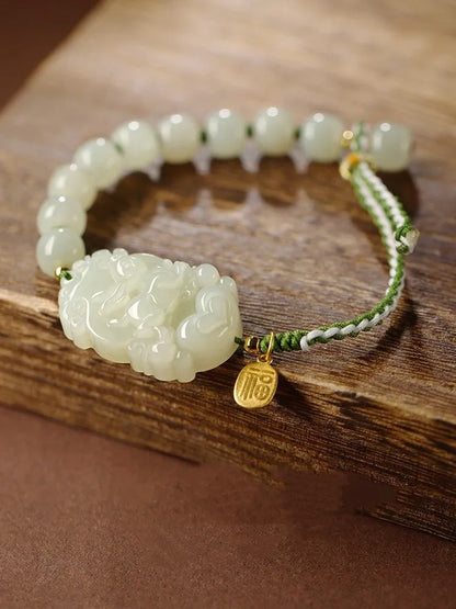 Hetian jade bracelet with a rabbit zodiac charm and S925 silver card on a red ice cotton rope.