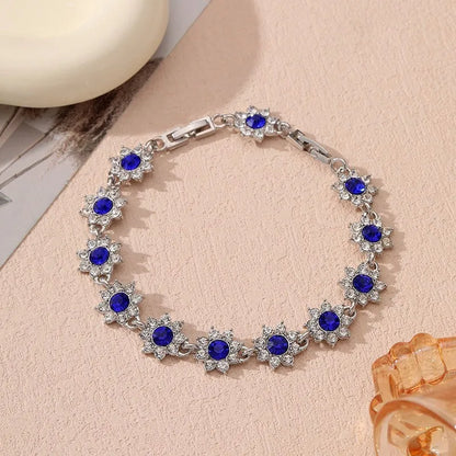 Floral shaped zinc alloy bracelet with electroplated colourful gem finishes in gold and silver tones.