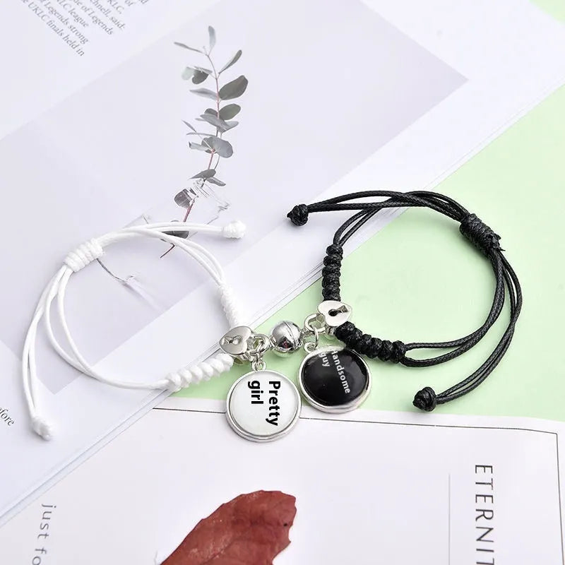 Magnetic suction couple bracelet pair in alloy with an electroplated finish, showing example designs like a crown and love lock.