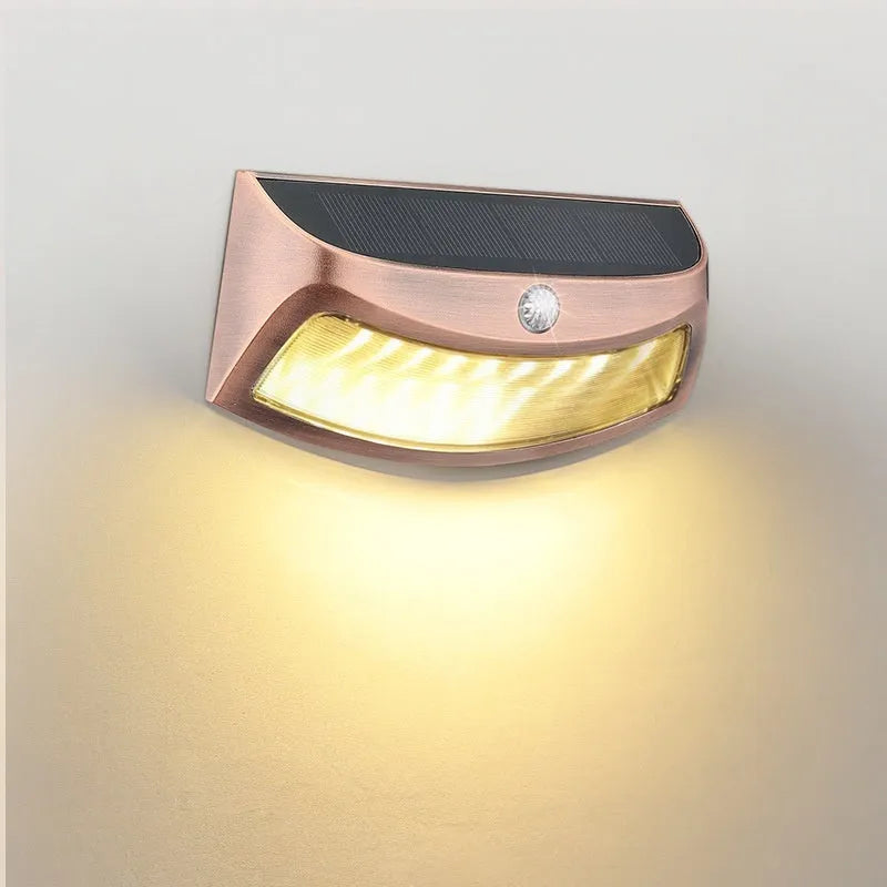 Solar outdoor wall lamp with smiling face design measuring 153mm × 76mm × 38mm for garden lighting