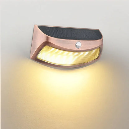 Solar outdoor wall lamp with smiling face design measuring 153mm × 76mm × 38mm for garden lighting