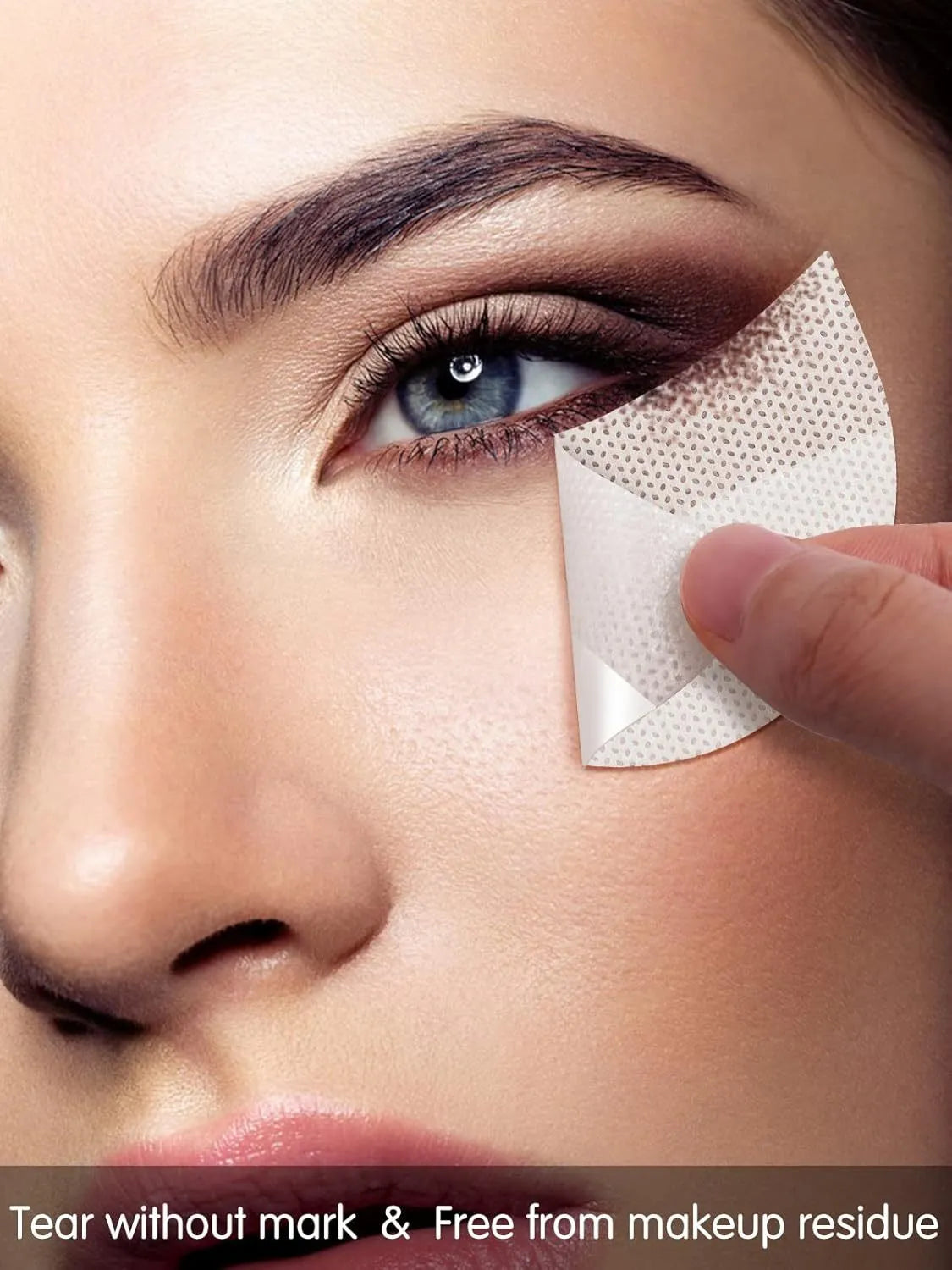 Pack of disposable half-moon shaped under-eye makeup shields on a pink background.